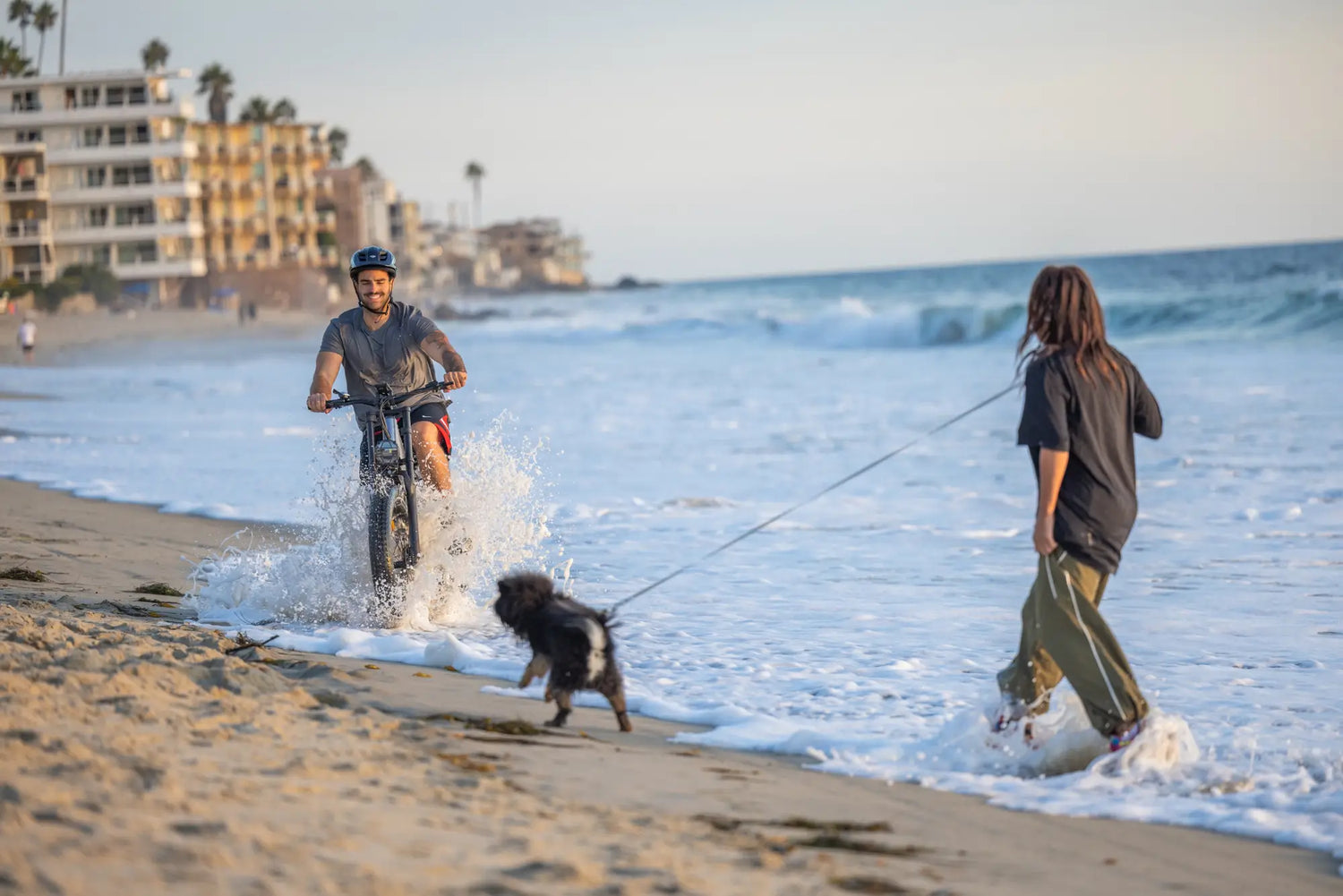 Man riding a bicycle happily playing on the beach