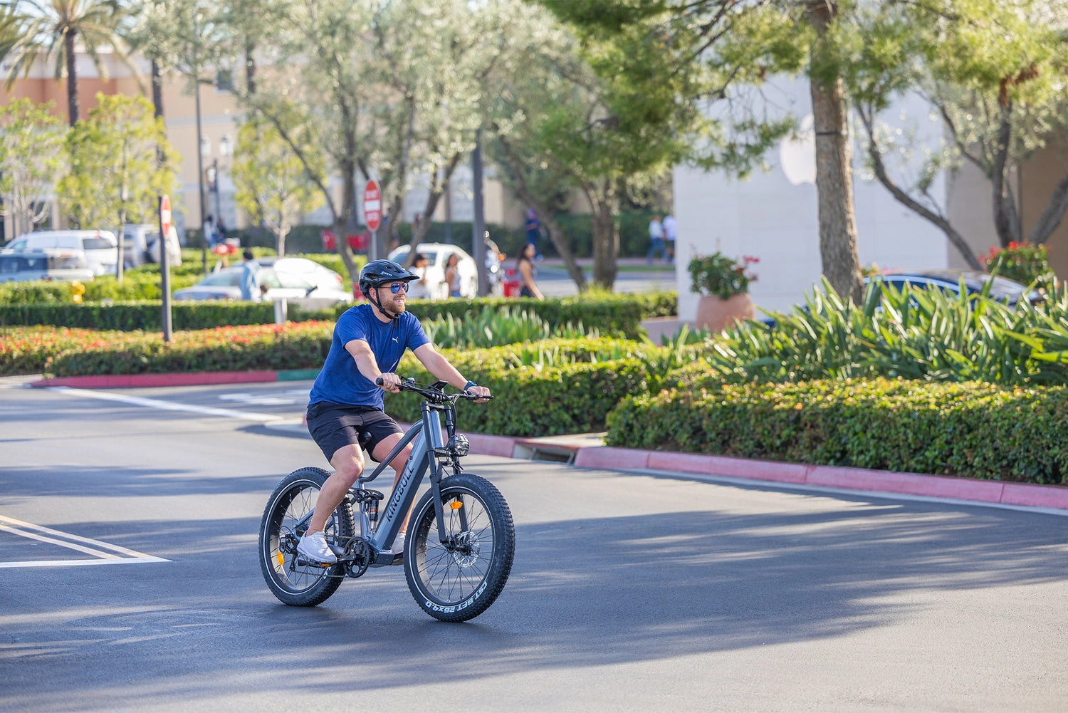 A man happily rides a Kingbull Rover 2.0 electric bicycle on the road
