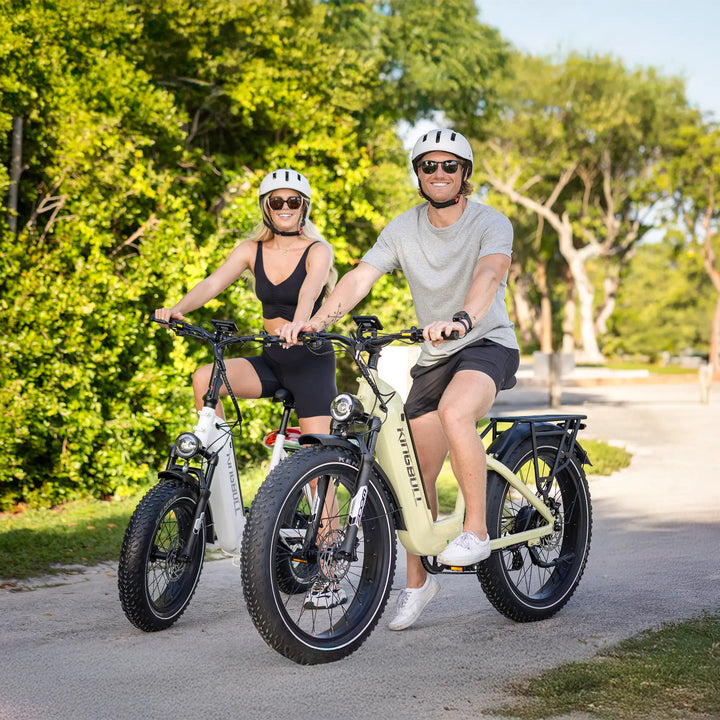 A couple riding their kingbull electric bicycles in the park with bright smiles