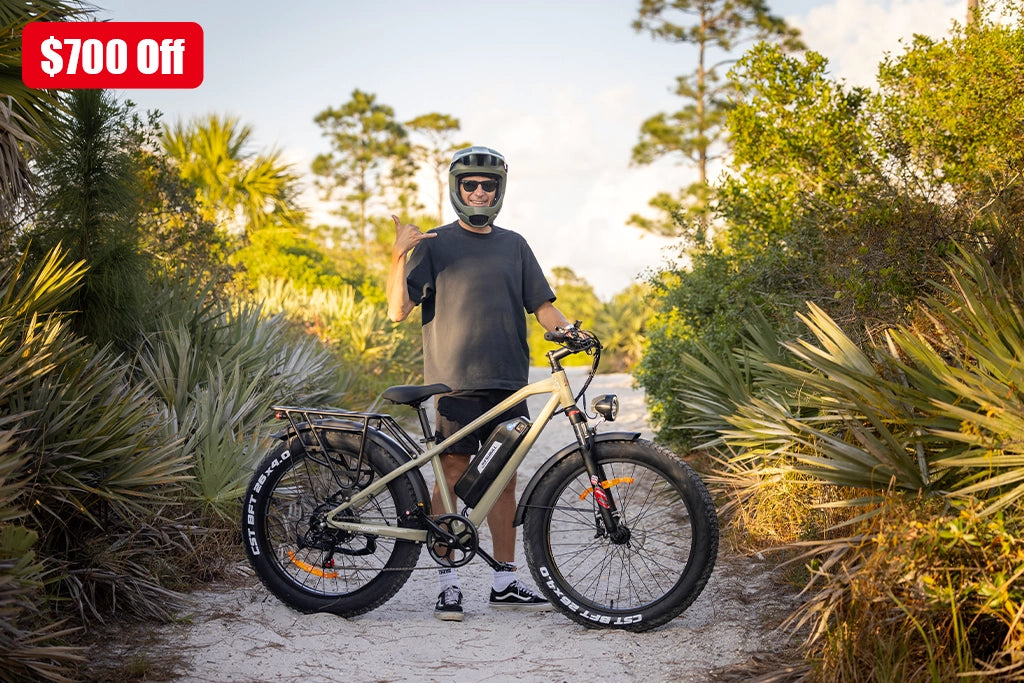 Save $700 on fat tire electric bikes - Rider with beige Kingbull Hunter 2.0 e-bike in tropical setting