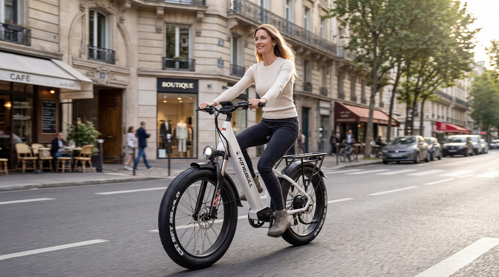 A tall woman happily rode a Kingbull Discover st 2.0 through the city streets.