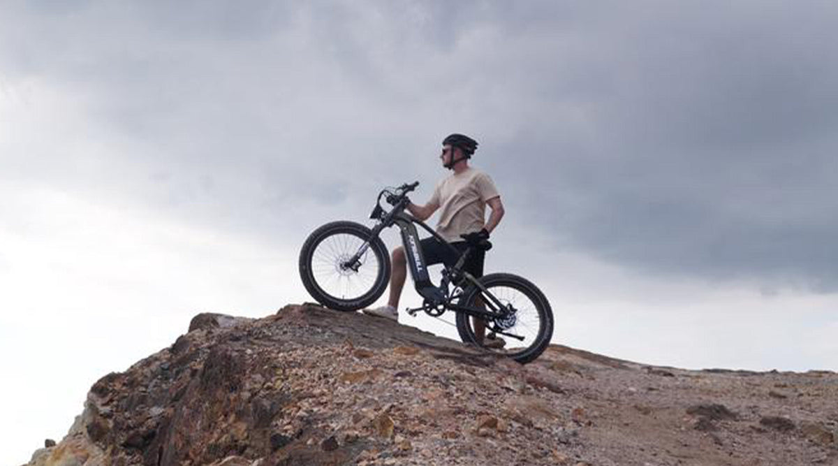 Trekker e-bike on rugged off-road terrain, highlighting its capability for trail riding, outdoor exploration, and adventurous rides beyond the pavement.