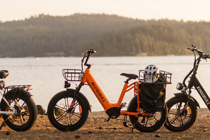 The orange freight electric bicycle kingbull voyager 2.0 is equipped with front and rear baskets and saddle bags, which can carry many items.