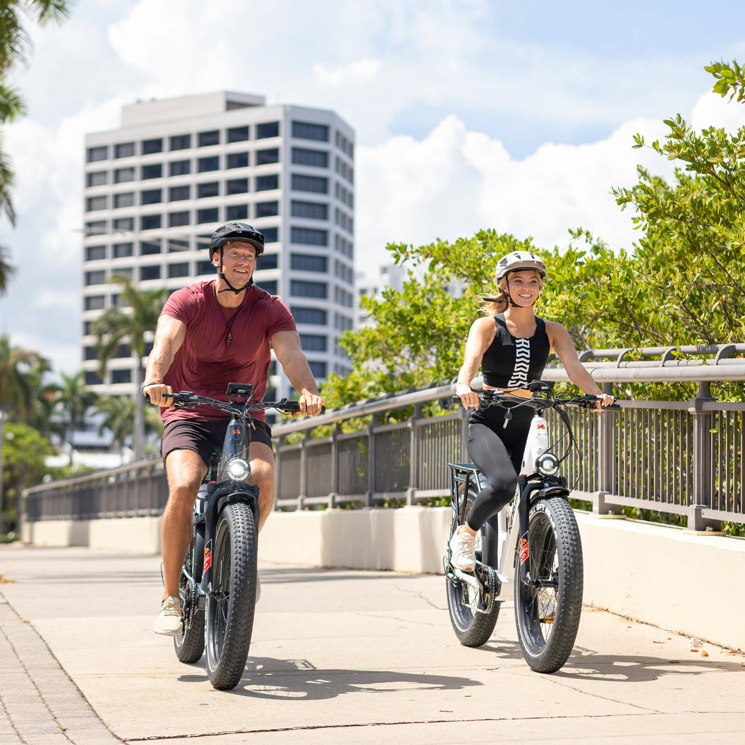 A couple riding Kingbull Discover 2.0 and Discover ST 2.0 on the city path