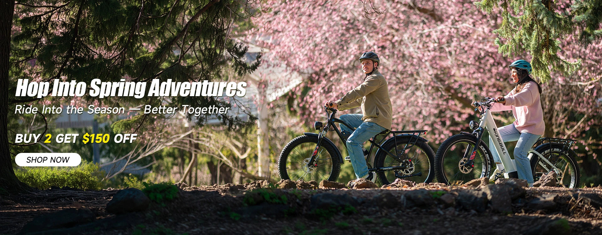 Easter Sale - Couple riding Kingbull hunter 2.0 off-road fat tire e-bike and Kingbull Discover ST 2.0 E-bike together on a scenic trail surrounded by spring cherry blossoms — Buy 2 Get $150 Off