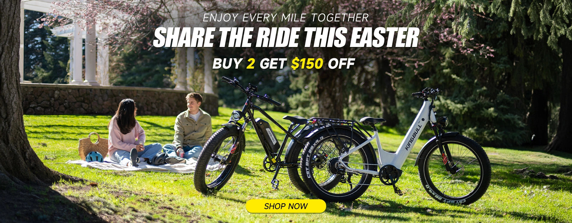 Black Kingbull hunter 2.0 off-road e-bike and white kingbull discover st 2.0 city e-bike parked on grass in a sunny park with cherry blossoms, Easter sale promotion offering $150 off when buying 2 bikes