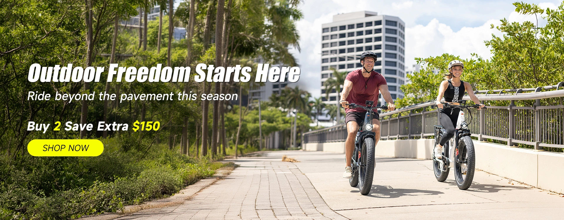 Two people riding Kingbull Discover 2.0 and Discover ST 2.0 electric bikes on a sidewalk with trees and buildings in the background, promotion is buy 2 save extra $150.