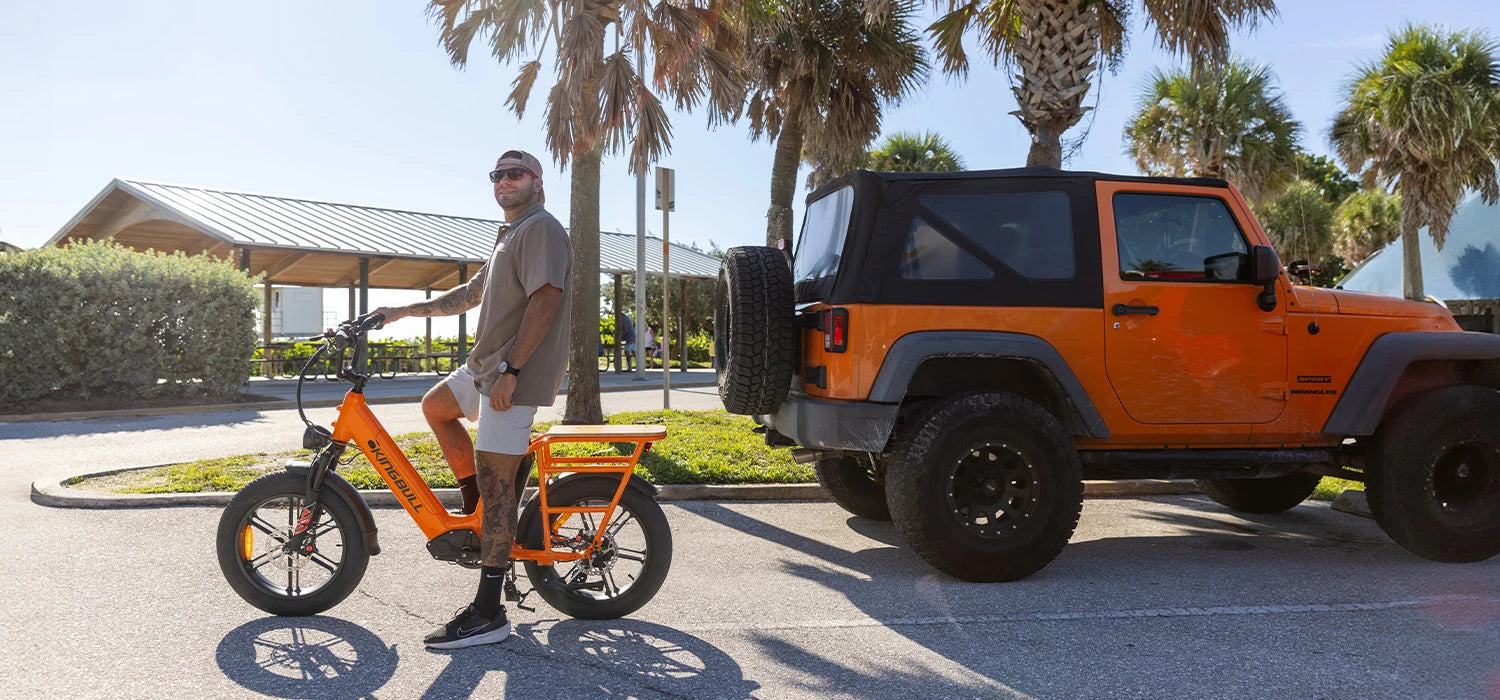 Man sitting on Kingbull electric bicycle voyager2.0 to observe traffic on the road
