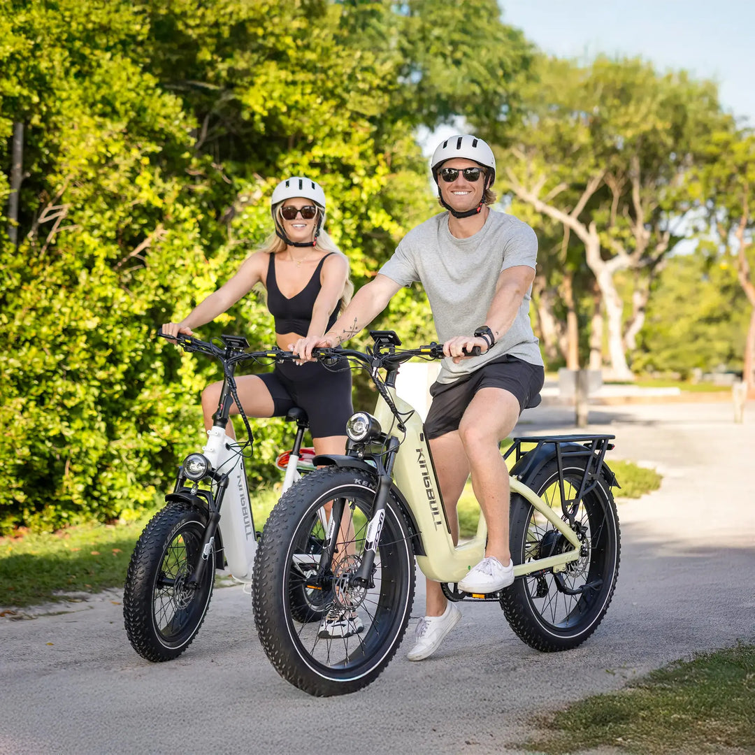 A couple riding their Kingbull Trekker electric bikes in the park with bright smiles.