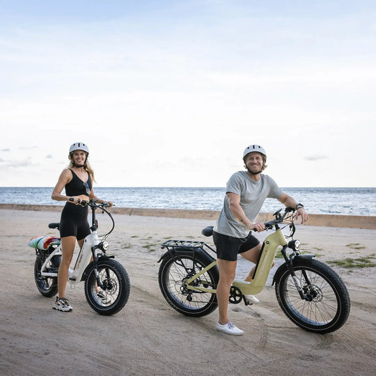 A man and a woman on the beach with their Kingbull Trekker electric bike