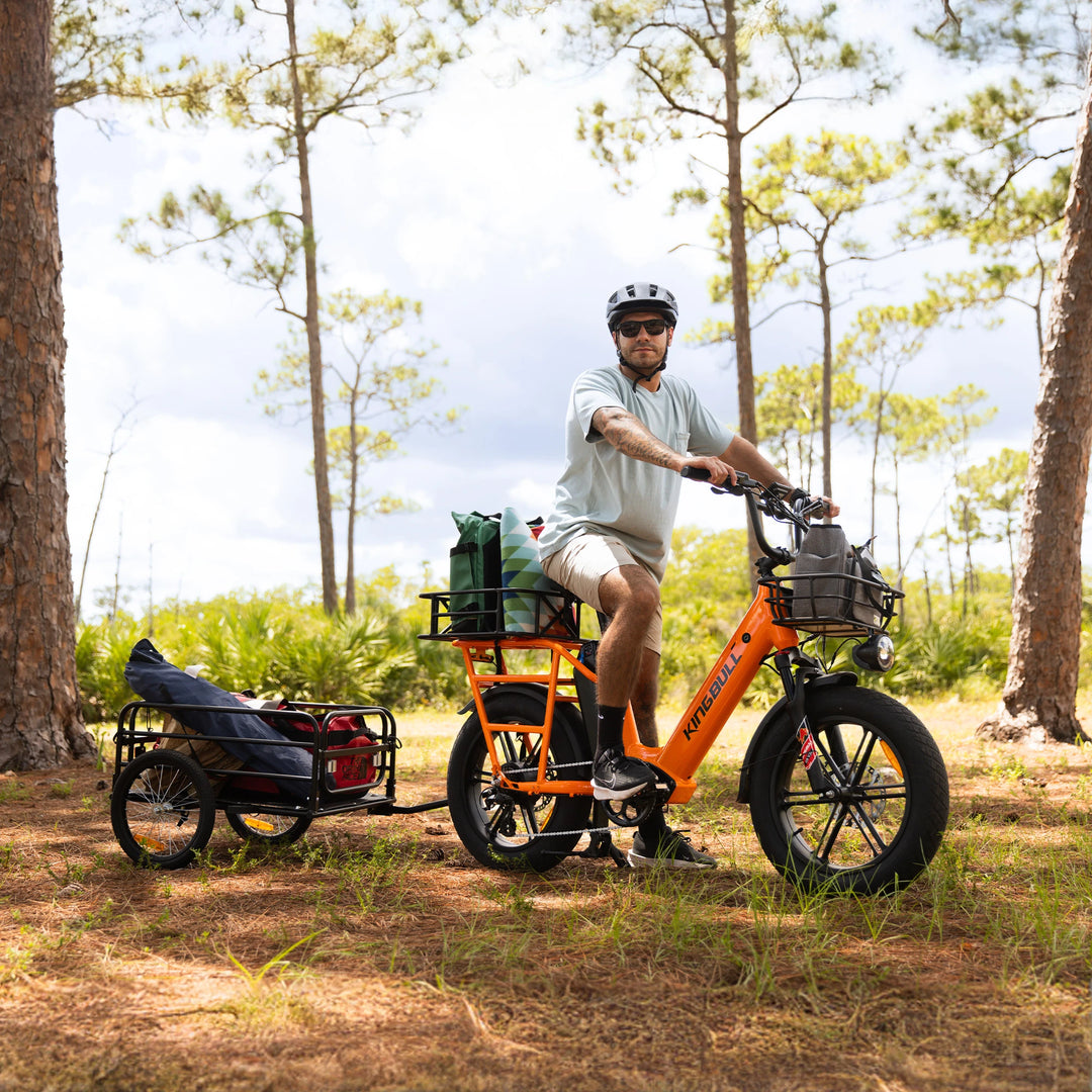 Man loads his outdoor camping equipment with kingbull freight electric bicycle kingbull voyager2.0