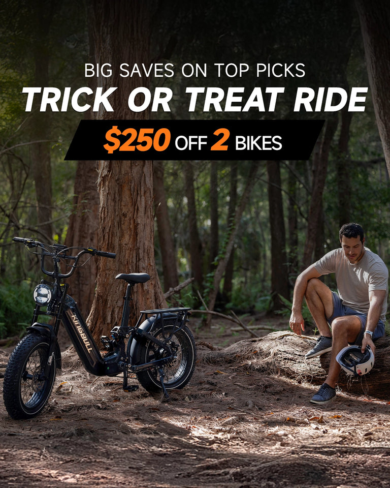 Gray Kingbull Jumper Go electric bike on forest trail with man resting - Trick or Treat promotion $250 off 2 bikes