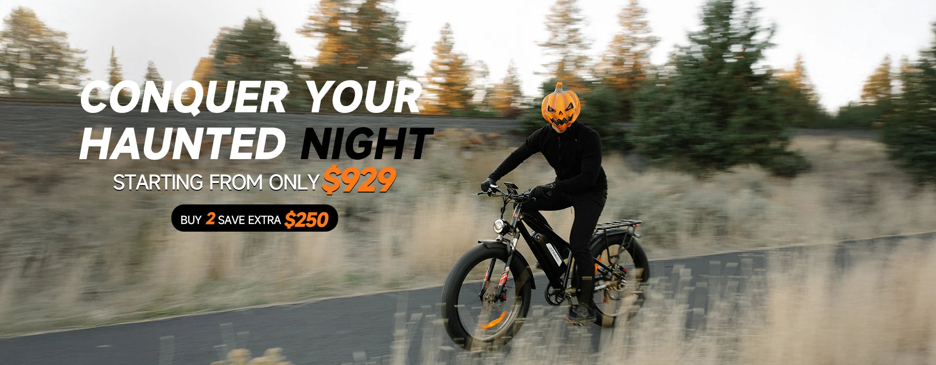 Person with pumpkin head riding Black Kingbull Hunter 2.0 electric bike on autumn trail - Halloween promotion starting at $929, buy 2 save $250