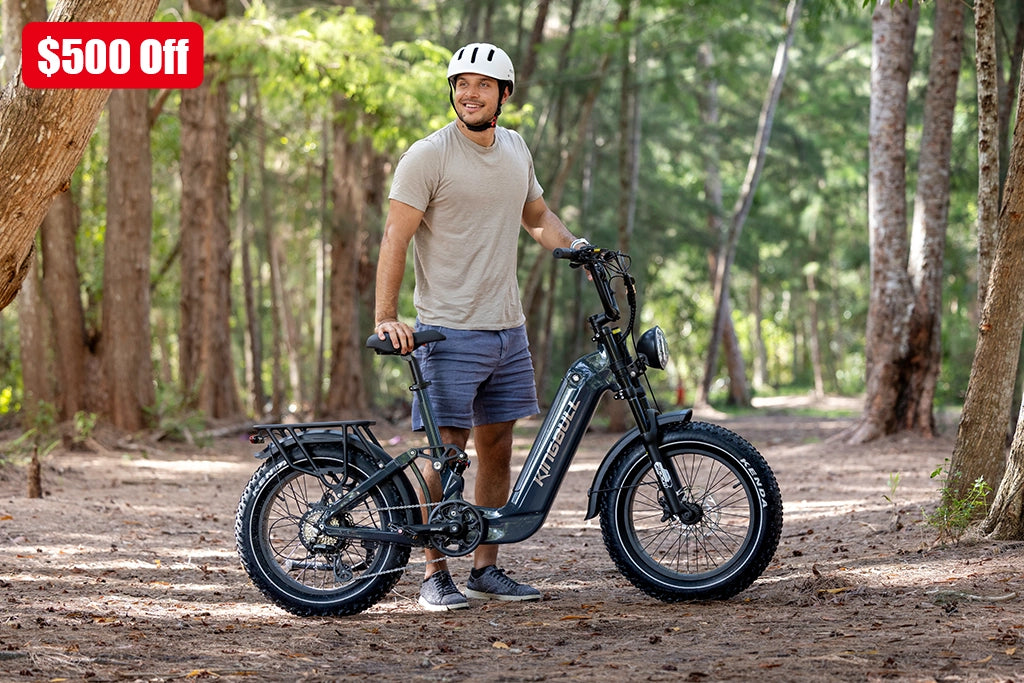 Save $500 on Kingbull Jumper Go electric bikes - Man with black e-bike in forest setting