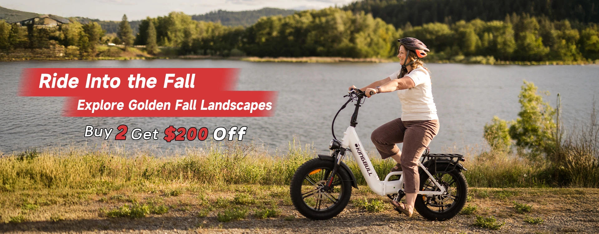 Woman riding white Kingbull Literider 2.0 electric bike by scenic lake with autumn foliage - Fall promotion Buy 2 Get $200 Off