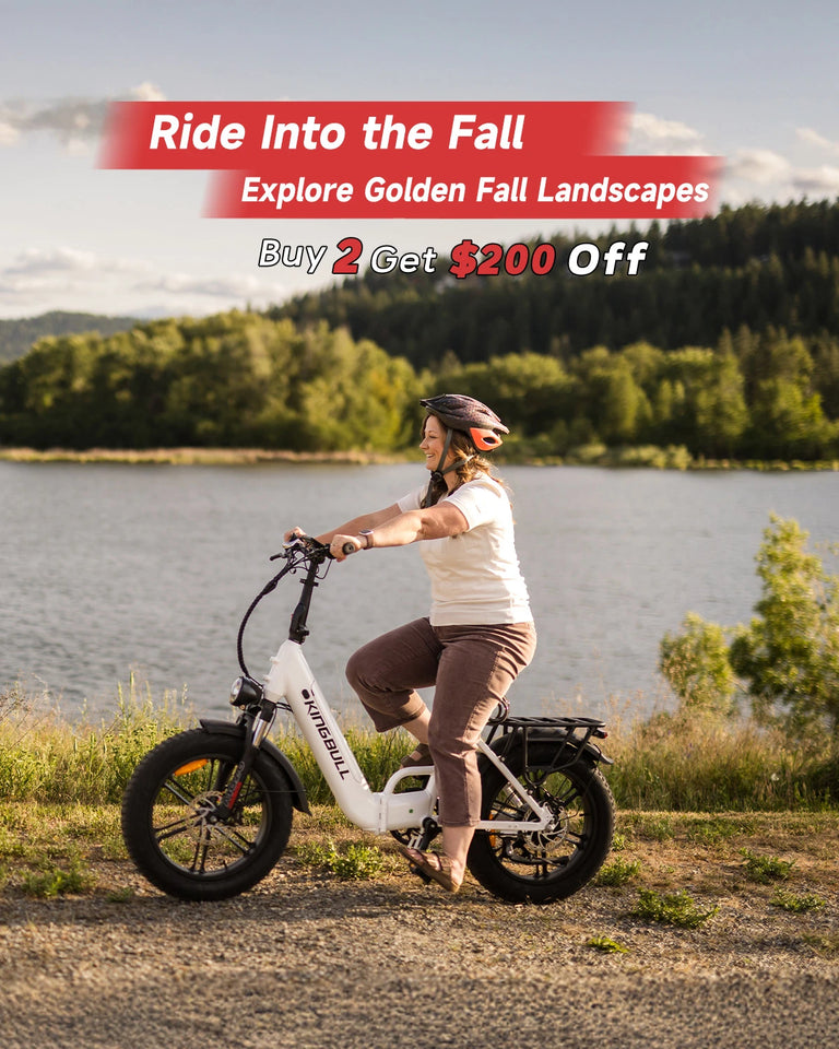 Woman riding white Kingbull Literider 2.0 electric bike by scenic lake with autumn foliage - Fall promotion Buy 2 Get $200 Off