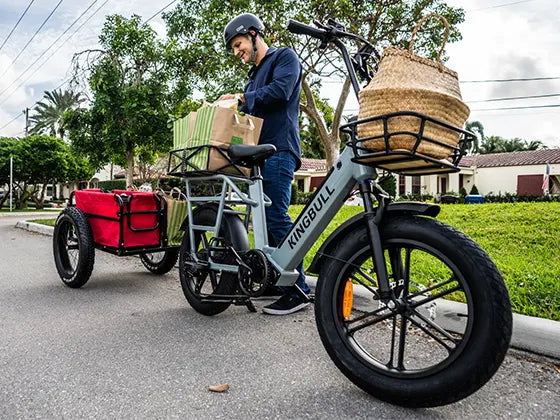 A man with a cargo e-bike loaded with goods