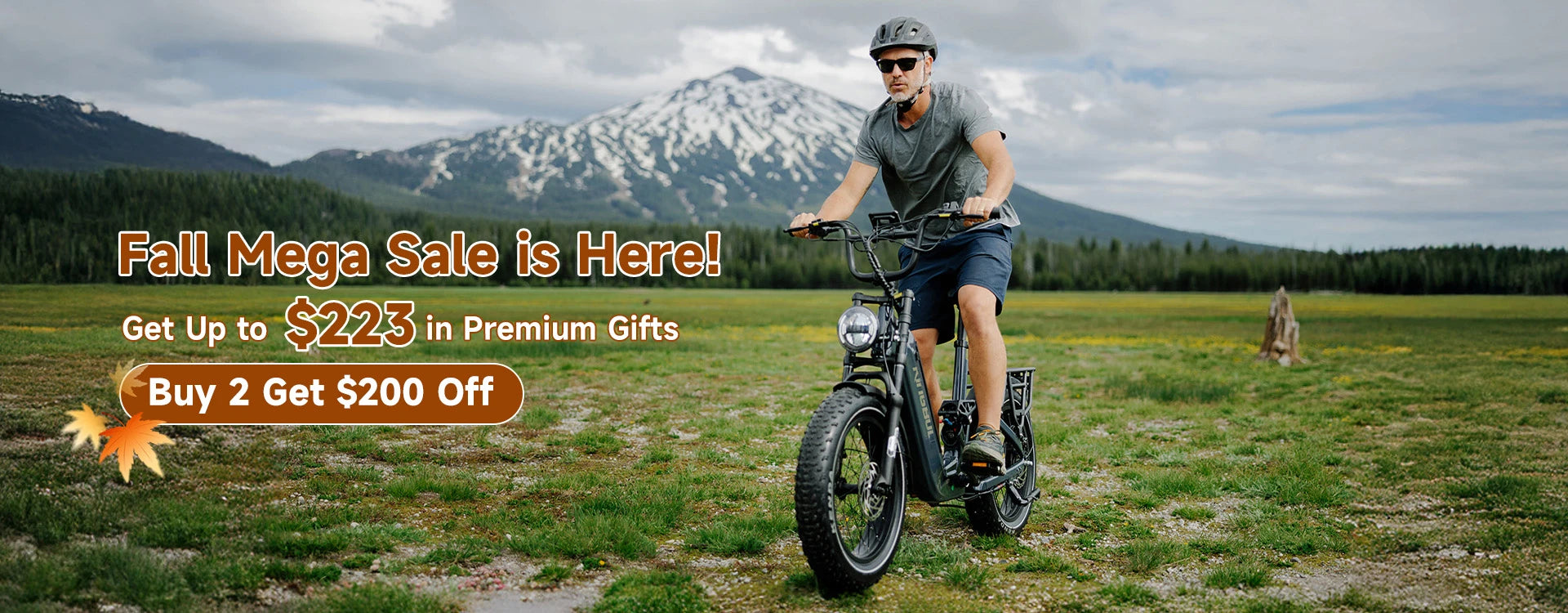 Fall Mega Sale promotion - Man riding the Kingbull Jumper Go e-bike in mountain meadow with snow-capped peaks, featuring up to $223 in premium gifts and buy 2 get $200 off deal